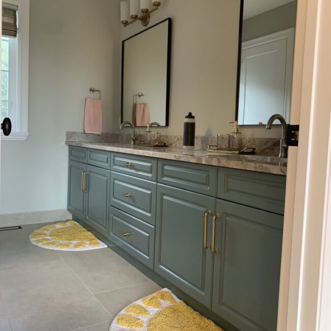 master bathroom with green cabinetry