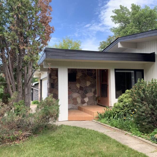 House with white siding and black features