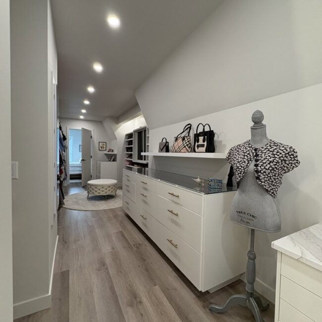 closet with white walls and cabinets