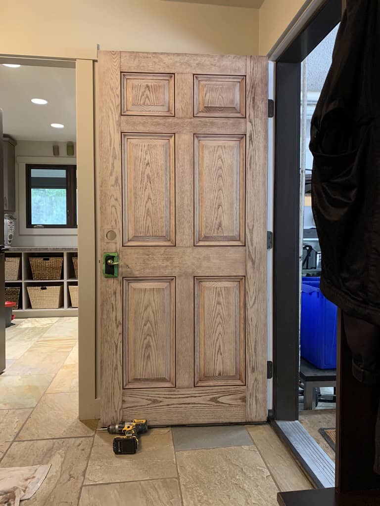 a wooden door with a screwdriver