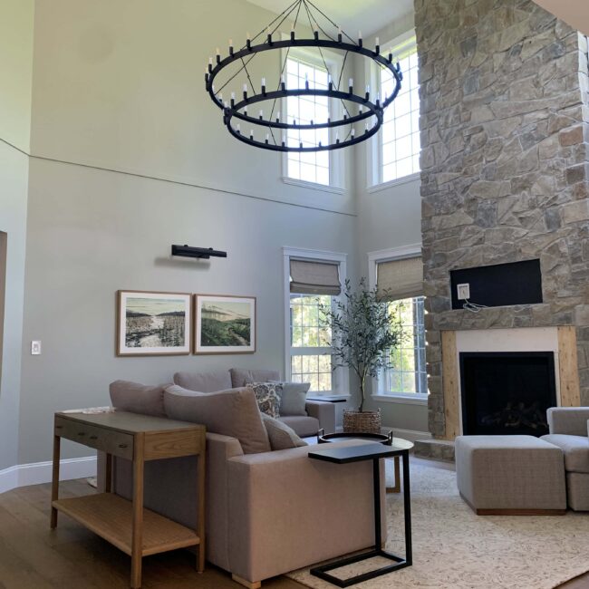 living room with fireplace that reaches the roof