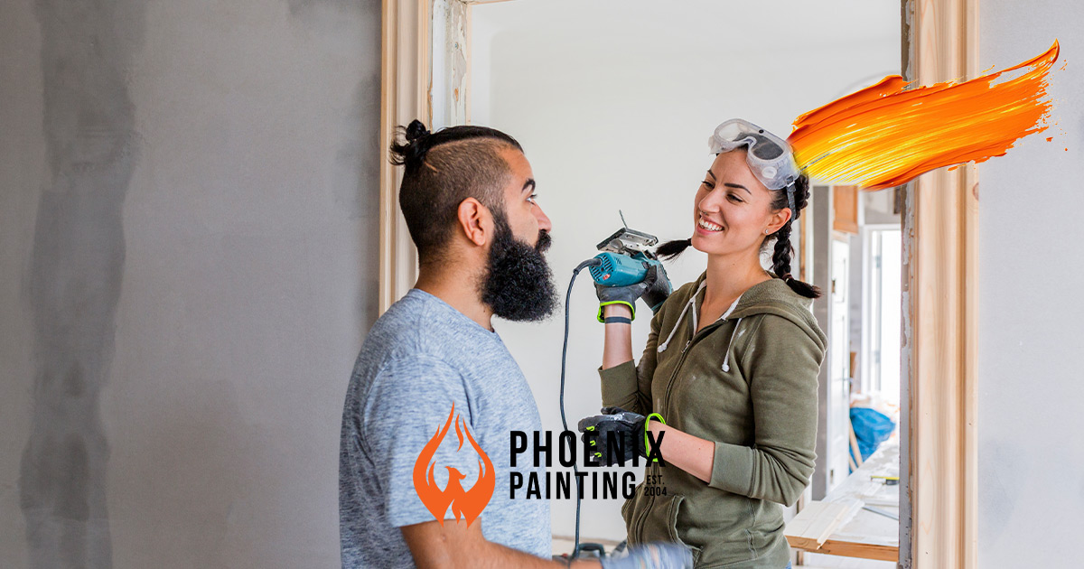 couple smiling at eachother doing a home improvement