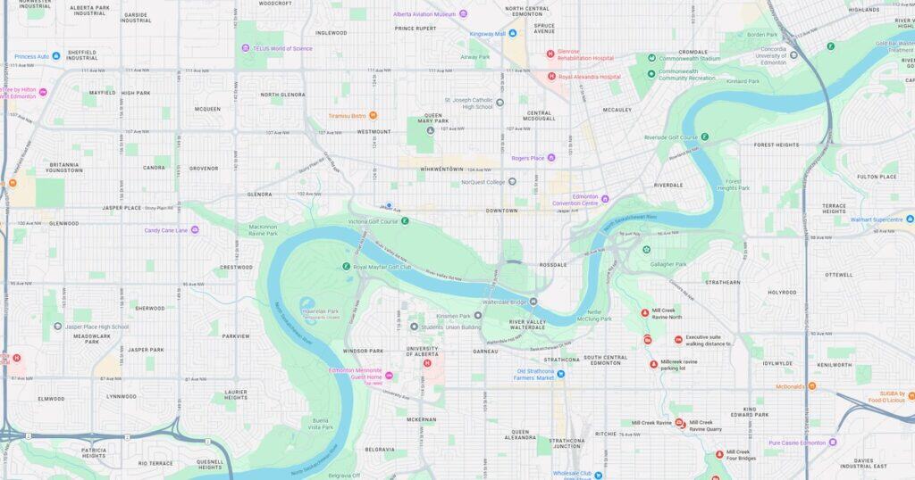 A detailed map of the river valley and surrounding neighborhoods in Edmonton, showing parks, bridges, and major landmarks including golf courses, hospitals, and residential areas. Ideal for urban planning or tourism content.