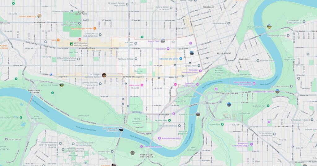 Map of downtown area showing streets, parks, and river in a city.